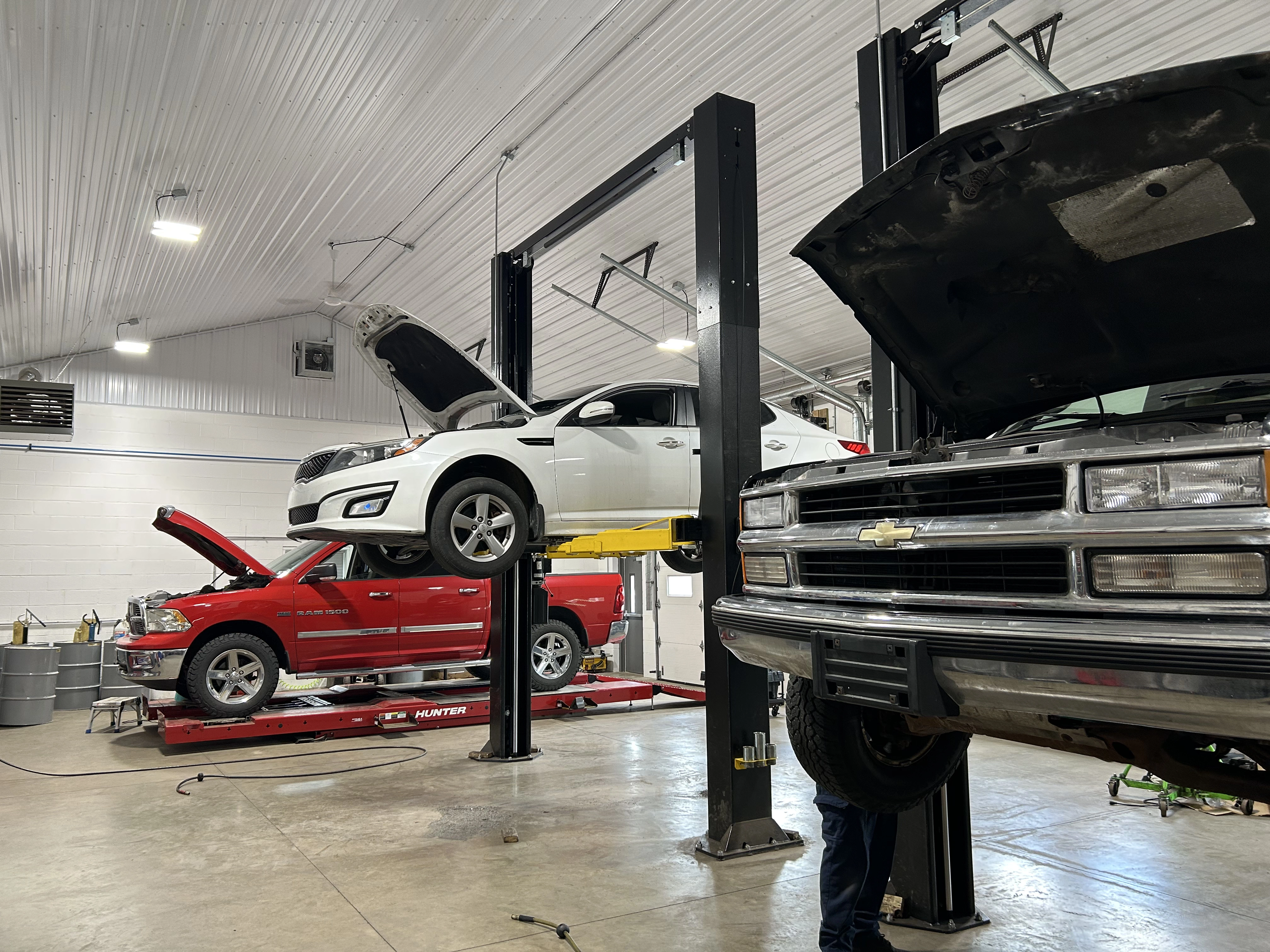 Vehicles being serviced inside the Witman Automotive shop